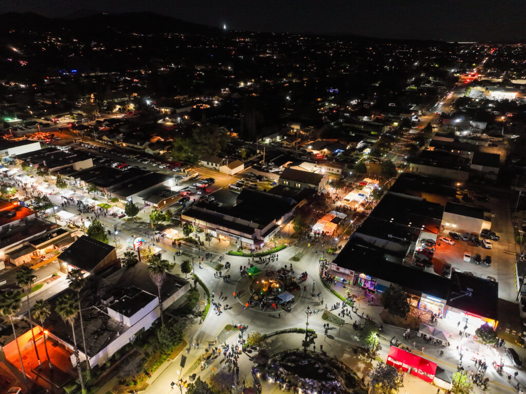 A Drone UAV of Palm Springs and Palm Desert, California, at Night with pretty city lighrs colorfully glittering